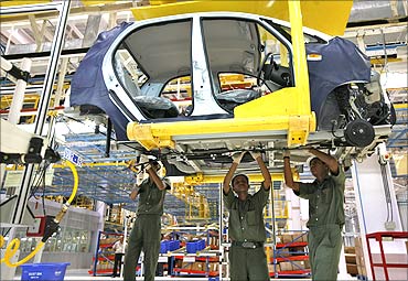 Employees work inside the newly inaugurated plant for the Tata Nano car at Sanand.