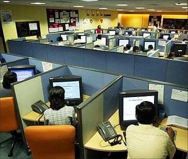 Indian employees at a call centre provide service support to international customers.