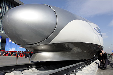 A visitor looks at the head of a CRH (China Railway High-speed) Harmony bullet train.