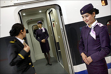 Stewardesses work on the bullet trains in new high-speed railway linking Shanghai and Hangzhou.