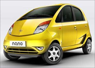 Onlookers stand next to Toyota's compact car 'Etios' at India's Auto Expo in New Delhi January 5, 2010.