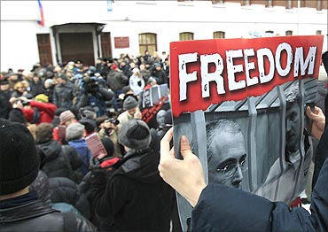 A man holds a portrait of Khodorkovsky and his partner Platon Lebedev.