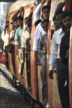 Image: Commuters travel in a suburban train in Mumbai. Photograph: Arko Datta/Reuters