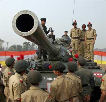 Image: Students from the National Cadet Corps stand on a tank at an exhibition organised by the Indian Army in Siliguri. Photograph: Rupak De Chowdhuri/Reuters