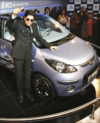 Bollywood superstar Shah Rukh Khan poses with Hyundai's i 10 electric car at India's Auto Expo in New Delhi.