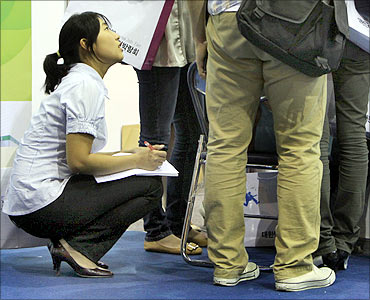 A job seeker fills in her curriculum vitae for an interview at the Korea Job Fair in Seoul.