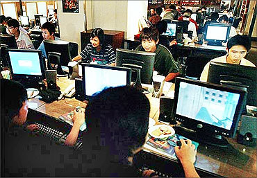 Teenagers play computer games in a Hong Kong Internet cafe.