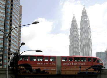 A monorail train moves past the Petronas Twin Towers in Kuala Lumpur.
