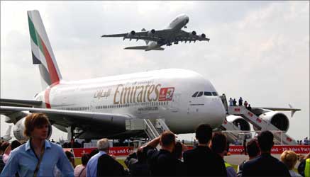 An Airbus A380 aircraft of Deutsche Lufthansa (top) passes over an Emirates A380.