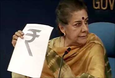 Union Broadcasting and Information Minister Ambika Soni unveiling the new rupee symbol.