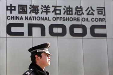 A security officer keeps watch outside the headquarters of China National Offshore Oil Corp.