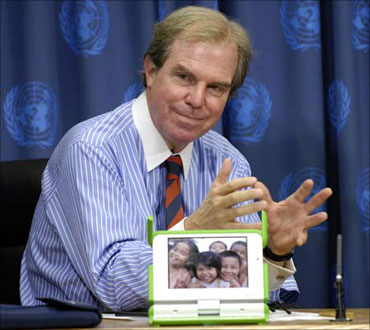 Nicholas Negroponte, shows a model of the $100 laptop computer he developed for the One Laptop per Child (OLPC) non-profit group.