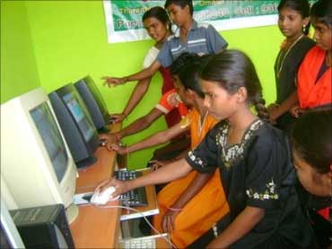 Village children attend computer class.