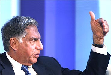 Ratan Tata gestures at a meeting.