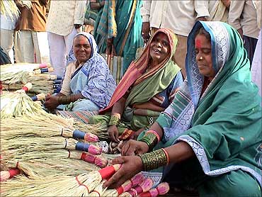 Mann Deshi Bank clients selling brooms.