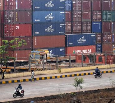 Car containers wait at a port to be shipped out.