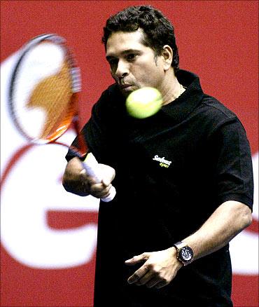 Sachin Tendulkar plays a shot during an exhibition match with Russia's Maria Kirilenko.