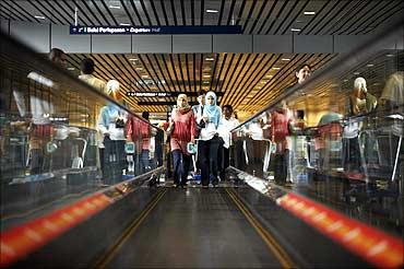 Women use the travelator at Kuala Lumpur airport.