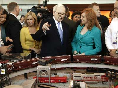 Buffett talks in front of BNSF model railroad. BNSF was bought by Berkshire Hathaway in February.