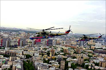 MI-24 military helicopters fly over the Moscow city.
