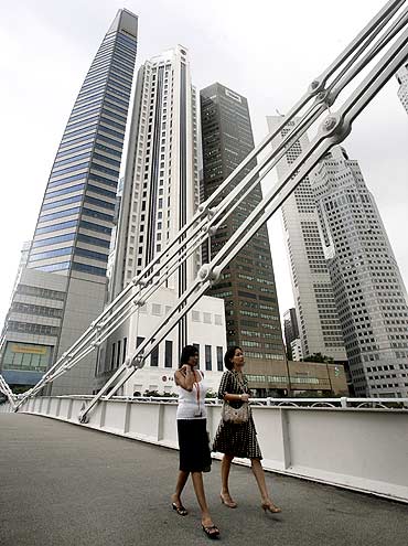 Office workers cross a bridge in Singapore's financial district.