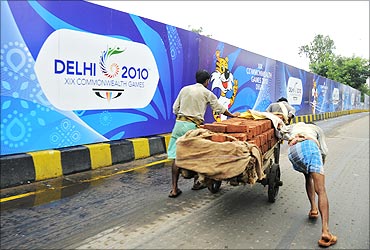 Labourers push a cart loaded with bricks over a flyover in New Delhi.