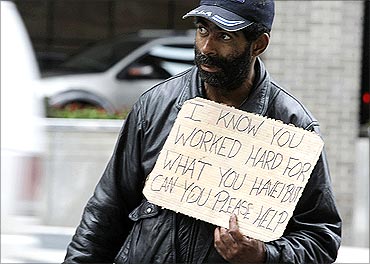 Harvey, a homeless man, begs for money along 14th Street in Washington.