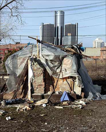 A makeshift home with General Motors headquarters in the background, in Detroit.