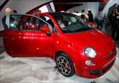 Visitors look at the new Fiat 500.