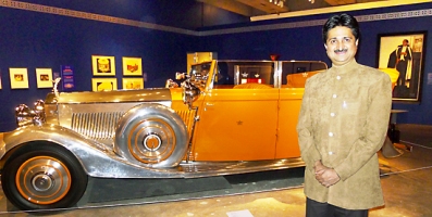 Maharaja YS Mandhatasinhji of Rajkot poses with Star of India Rolls Royce.