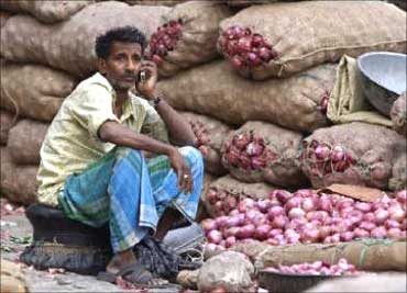 An onion vendor speaks on his mobile phone.