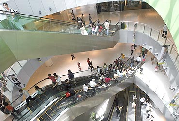 Shoppers use escalators at a shopping centre in Singapore.