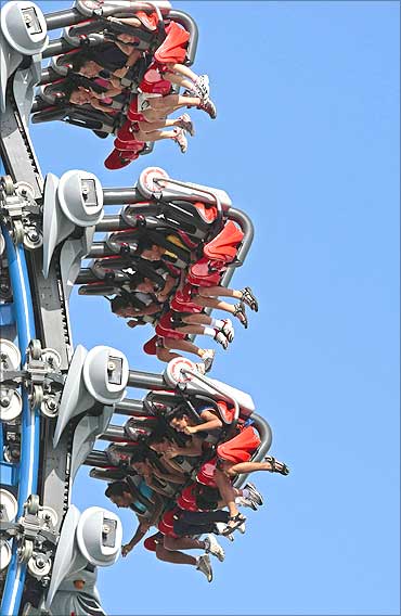 Visitors ride the Battlestar Galactica dueling roller coaster at the Universal Studios theme park in Singapore.