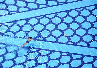 A man swims in a pool inside a condominium in Singapore.