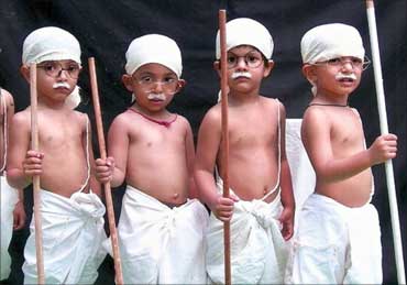 School children dressed as Mahatma Gandhi take part in a cultural programme in Bhopal.