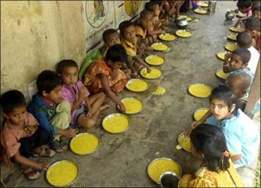 Students have a free meal distributed by a government-run school in Nalchar village, near Agartala.