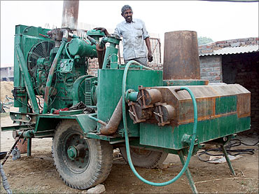 Rai Singh with the earlier version of the gasifier.