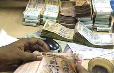 A bank teller counting notes.