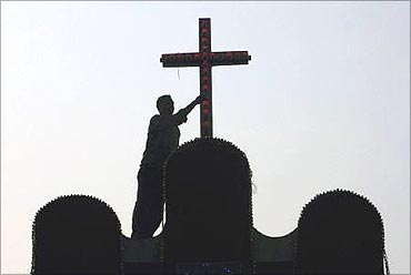 A worker on the roof of a church.