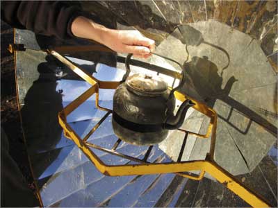 A kettle is placed on a solar cooker in a village in Argentina.