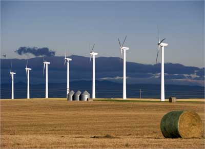 Windmills generate electricity at the foothills of Rocky Mountains, Alberta.