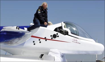 Virgin Group head Sir Richard Branson sits on top of a solo piloted submarine during a photo opportunity at a news conference in Newport Beach, California on April 5, 2011.