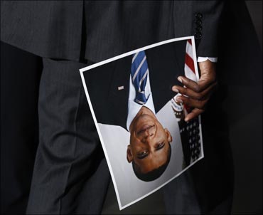US President Barack Obama's personal assistant Reggie Love carries a photograph of Obama.