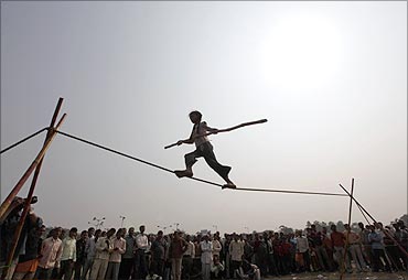Eight-year-old Rupa performs on a tightrope at a roadside in Kolkata.