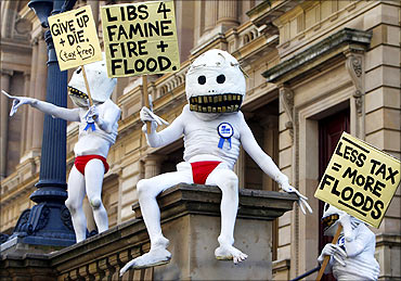 Protesters dressed in costumes are seen at a rally in favour of taxing carbon emissions in Melbourne.