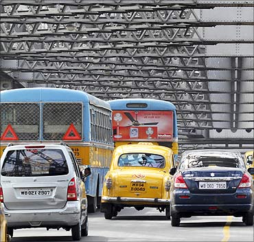 Traffic moves across Howrah Bridge in Kolkata.
