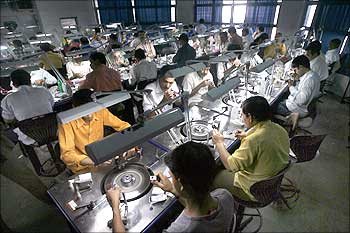 Workers work at a diamond polishing unit.