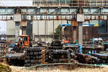 Workers at JFE Steel Corp's facility in an area devastated by the March 11 earthquake and tsunami, in Sendai, Miyagi prefecture.