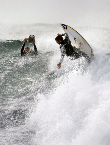 A surfer battles the waves in Sydney.