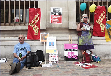 Demonstrators rest after a protest over pension reforms in London.
